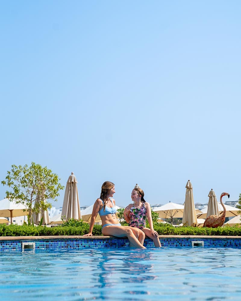 Friends unwinding with food and drinks at Riva Beach Club